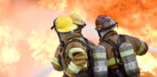 firefighters attempt to extinguish large flames