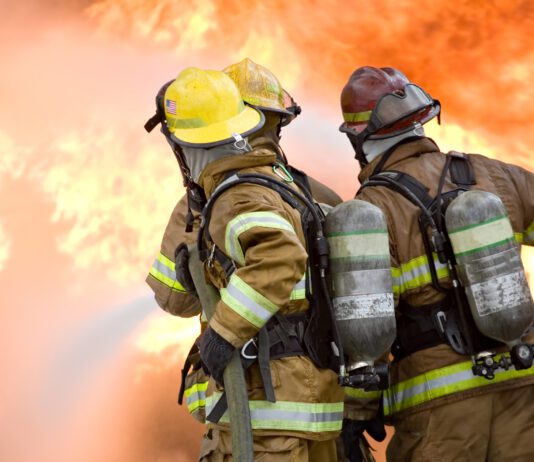 firefighters attempt to extinguish large flames