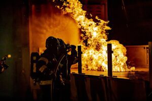 firefighters attempting to put out large Apartment fire