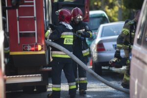 firemen work to extinguish house fire