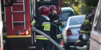 firemen work to extinguish house fire