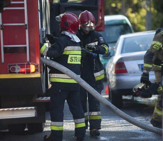 firemen work to extinguish house fire