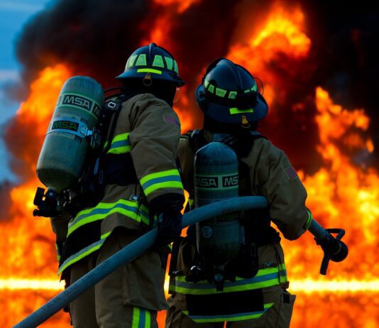 Firefighters attempt to extinguish large flames.