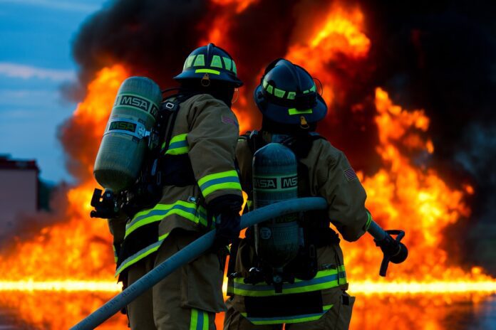Firefighters attempt to extinguish large flames.